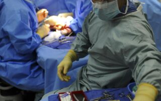 Group of anesthesiology residents training in an operating room