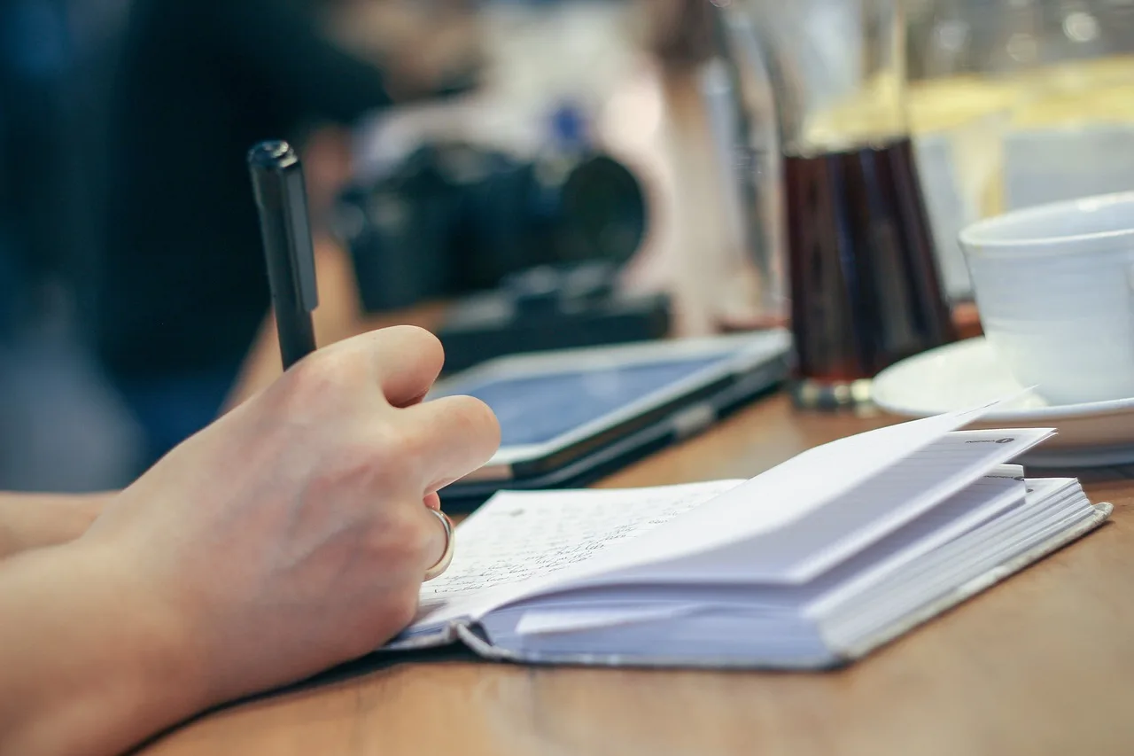 Student writing in notebook